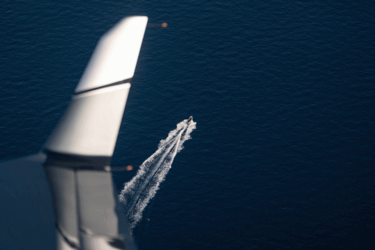 An abandoned boat left drifting in the open sea.