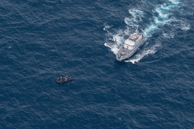 A vessel of the Libyan Coast Guard approaching an overcrowded boat in distress during an illegal in